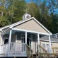 Custom timber frame home built by Level Headed Builders in Springfield VT with beige shake siding and a rooftop cupola